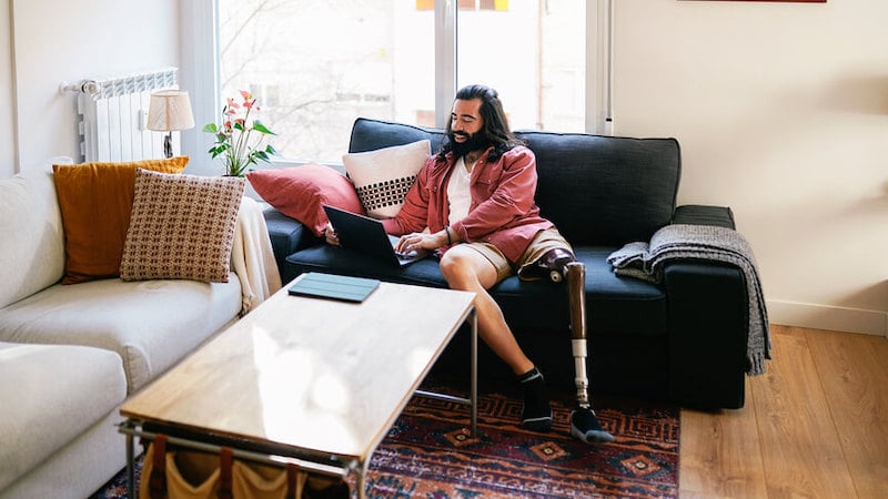 talent-marketplace-man-on-couch-laptop